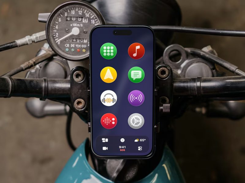 An iPhone running CarOS on a motorcycle's handlebars, next to the speedometer