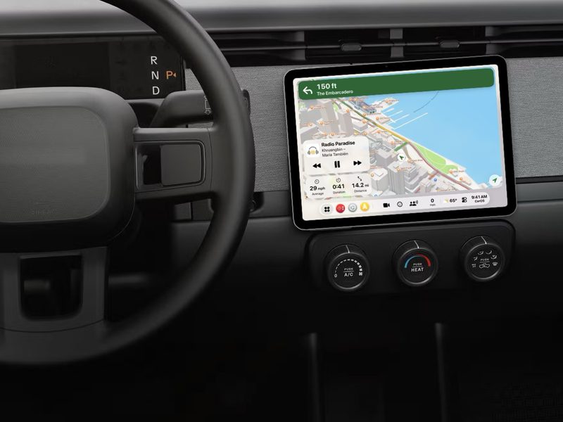 An iPad running CarOS on the dashboard of a pickup truck with no built-in screen